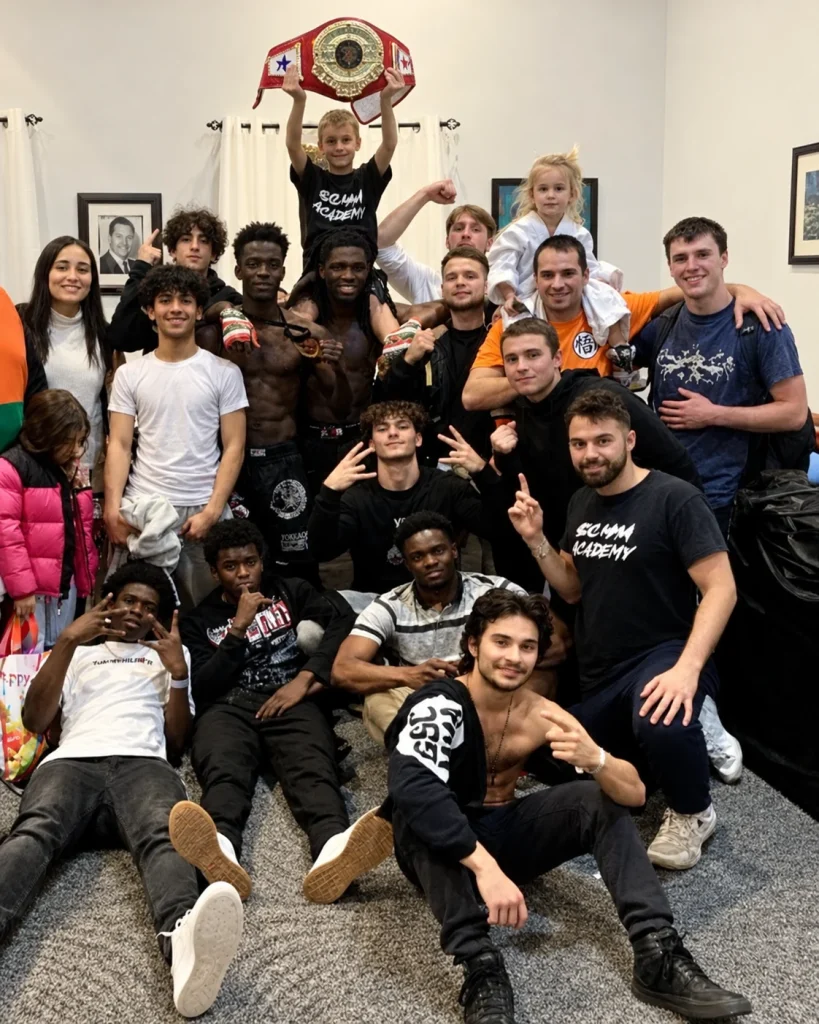 Groupe de GSC MMA réuni avec un enfant tenant une ceinture de championnat