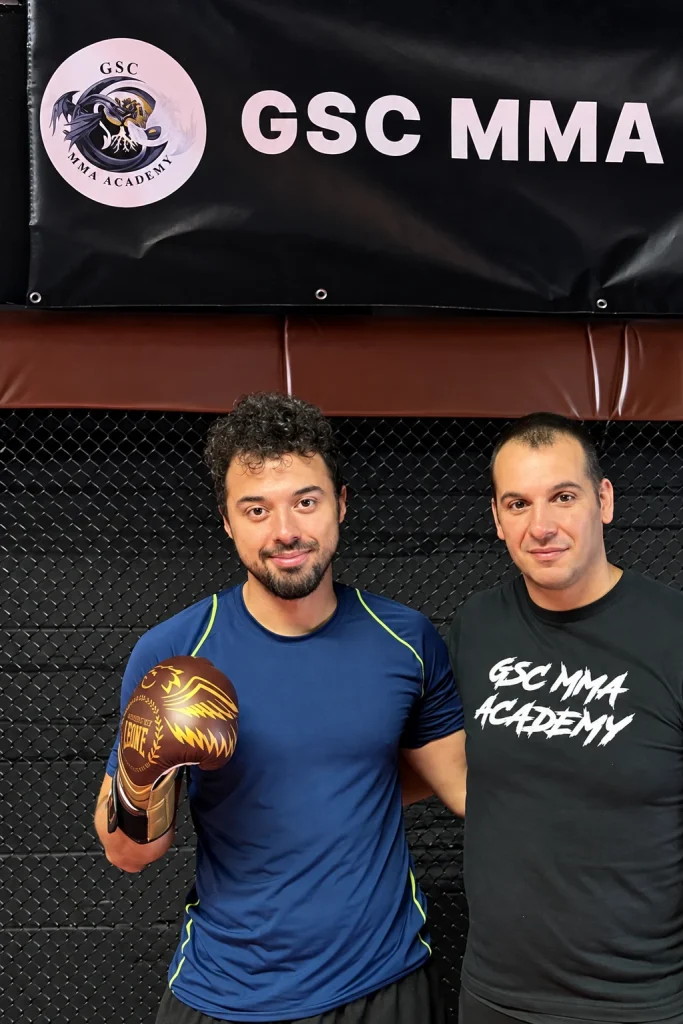 Deux personnes posent devant la bannière GSC MMA